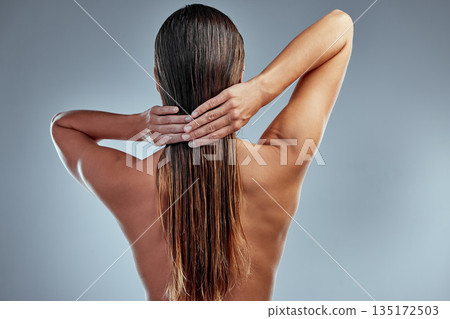 Hair care, beauty and back of woman in a studio with a clean, long and wet hairstyle with conditioner. Health, wellness and female model with a keratin or salon treatment isolated by gray background. Hair care, beauty and back of woman in a studio with a clean, long and wet hairstyle with conditioner. Health, wellness and female model with a keratin or salon treatment isolated by gray background. 135172503