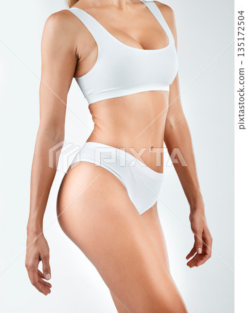 Body, diet and woman in lingerie in studio for wellness, health and lose weight on white background. Underwear, detox and female model with cosmetic, treatment and glowing, skin and slimming results Body, diet and woman in lingerie in studio for wellness, health and lose weight on white background. Underwear, detox and female model with cosmetic, treatment and glowing, skin and slimming results 135172504