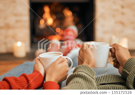 Hands, coffee and couple relax by fireplace, bonding and cozy in home together. Tea, man and woman relaxing by fire on Christmas holiday in winter, heat and enjoying quality time with drinks in house Hands, coffee and couple relax by fireplace, bonding and cozy in home together. Tea, man and woman relaxing by fire on Christmas holiday in winter, heat and enjoying quality time with drinks in house 135172526