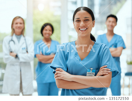 Portrait, medical and a woman nurse arms crossed, standing with her team in the hospital for healthcare. Leadership, medicine and teamwork with a female health professional in a clinic for treatment 135172550