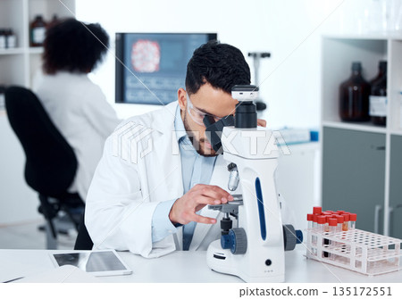 Science, particles and scientist analyzing with a microscope in a medical laboratory with concentration. Biotechnology, pharmaceutical and male researcher working on scientific project for healthcare Science, particles and scientist analyzing with a microscope in a medical laboratory with concentration. Biotechnology, pharmaceutical and male researcher working on scientific project for healthcare 135172551