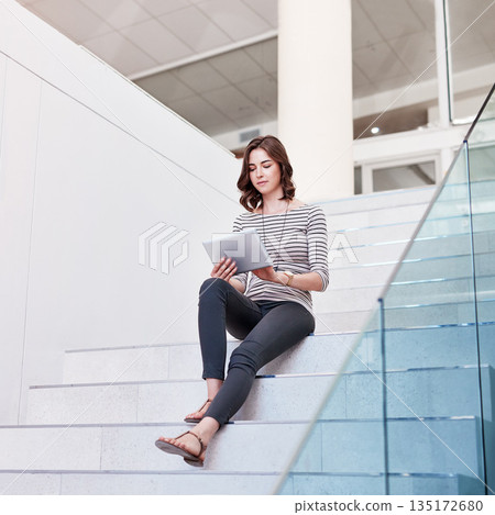 Tablet, research and woman on the staircase in the office planning a corporate project. Technology, career and professional female employee working on company report with digital mobile in workplace. Tablet, research and woman on the staircase in the office planning a corporate project. Technology, career and professional female employee working on company report with digital mobile in workplace. 135172680