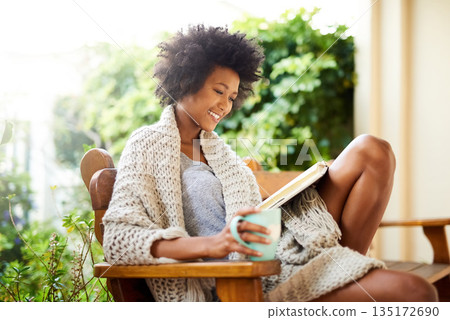 Woman, tea and reading book in garden and backyard patio feeling relax and happy. Happiness, black female person and smile in a home garden in the morning with coffee outdoor in sun and backyard Woman, tea and reading book in garden and backyard patio feeling relax and happy. Happiness, black female person and smile in a home garden in the morning with coffee outdoor in sun and backyard 135172690