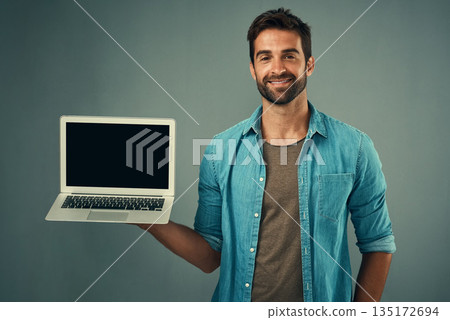 Happy man, laptop and mockup screen for advertising or marketing against a grey studio background. Portrait of male person with smile showing computer display or mock up space for advertisement Happy man, laptop and mockup screen for advertising or marketing against a grey studio background. Portrait of male person with smile showing computer display or mock up space for advertisement 135172694