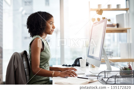 Computer, typing and business woman in office for online research, copywriting and editing for job website. Young african person, editor or journalist on desktop pc or monitor for article or report Computer, typing and business woman in office for online research, copywriting and editing for job website. Young african person, editor or journalist on desktop pc or monitor for article or report 135172820
