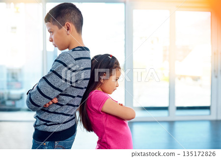 Anger, brother and sister in home living room, fighting or argument, conflict or problem. Angry, children and kids with arms crossed with their backs together, frustrated and ignore at home 135172826
