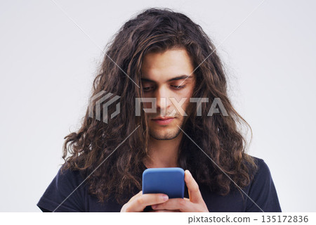 Phone, communication and face of man in studio typing for social media post, internet and online chat. Mockup, white background and male person on smartphone for website, mobile app and networking Phone, communication and face of man in studio typing for social media post, internet and online chat. Mockup, white background and male person on smartphone for website, mobile app and networking 135172836