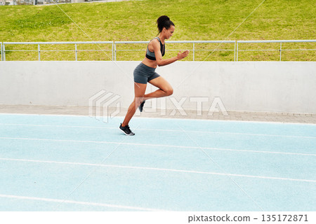 Woman, cardio and running on stadium track for training, physical exercise or workout. Active, fit or sporty female person, athlete or runner in sports run, race or competition for healthy wellness Woman, cardio and running on stadium track for training, physical exercise or workout. Active, fit or sporty female person, athlete or runner in sports run, race or competition for healthy wellness 135172871