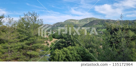 Lush green hills under blue sky Lush green hills under blue sky 135172964