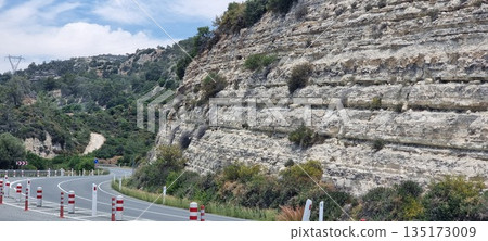 Mountain road curve with rocky cliff Mountain road curve with rocky cliff 135173009
