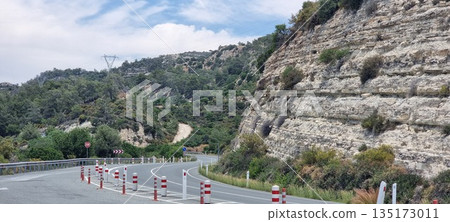 Mountain road curve with rocky cliff Mountain road curve with rocky cliff 135173011