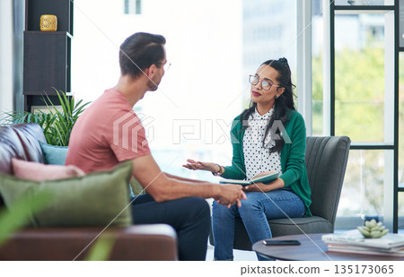 Mental health, therapy or counseling with a woman psychologist and male patient talking in her office. Psychology, wellness and trust with a female doctor or shrink consulting a man for healing Mental health, therapy or counseling with a woman psychologist and male patient talking in her office. Psychology, wellness and trust with a female doctor or shrink consulting a man for healing 135173065