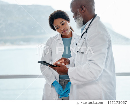 African doctors, teamwork and talking with tablet, data analysis or results for healthcare in hospital. Senior black man, woman and medical discussion with digital touchscreen for wellness in clinic African doctors, teamwork and talking with tablet, data analysis or results for healthcare in hospital. Senior black man, woman and medical discussion with digital touchscreen for wellness in clinic 135173067