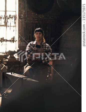 Blacksmith, workshop and portrait of woman with tools for industry, manufacturing and machinery. Industrial factory, welding and female person for steel, iron and metal production for craftsmanship 135173071