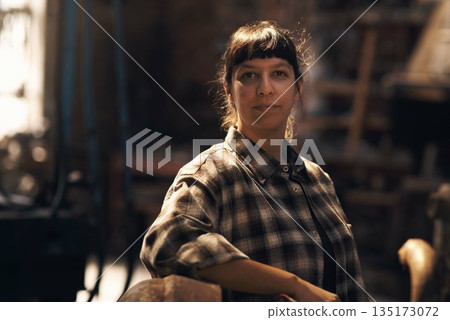 Woman blacksmith, portrait and workshop for industry, trade or artisan job for entrepreneurship. Small business owner, female entrepreneur or confident in factory, industrial warehouse or metalwork 135173072