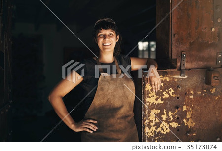 Woman blacksmith, portrait and smile in factory, industry and trade for entrepreneurship at artisan job. Small business owner, female entrepreneur and labor in industrial warehouse with manufacturing 135173074