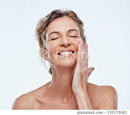 Skincare, smile and a woman with an anti aging cream isolated on a white background in a studio. Happy, moisturize and a mature model with facial lotion for beauty, wellness and care of skin Skincare, smile and a woman with an anti aging cream isolated on a white background in a studio. Happy, moisturize and a mature model with facial lotion for beauty, wellness and care of skin 135173081