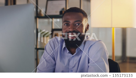 Business man, portrait and computer at night while working at a desk for report or deadline. Happy black male entrepreneur with technology for marketing, internet connection or productivity in office Business man, portrait and computer at night while working at a desk for report or deadline. Happy black male entrepreneur with technology for marketing, internet connection or productivity in office 135173133