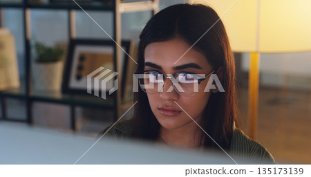 Computer, night and face with a woman editor working in her office for a journalism or news report. Focus, editing and reporting with a young journalist at work on a desktop for online content Computer, night and face with a woman editor working in her office for a journalism or news report. Focus, editing and reporting with a young journalist at work on a desktop for online content 135173139