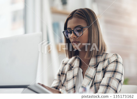 Copywriting, laptop and business woman typing in office workplace. Writer, computer and female Indian person reading, working or writing email, report or proposal, research online or planning project Copywriting, laptop and business woman typing in office workplace. Writer, computer and female Indian person reading, working or writing email, report or proposal, research online or planning project 135173162