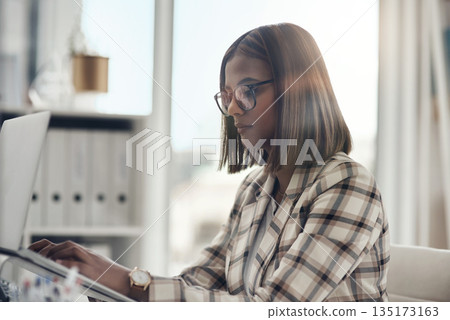 Laptop, editor and business woman typing in office workplace. Writer, computer and female Indian person reading, working or writing email, report or proposal, research online or planning project. 135173163