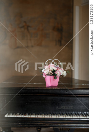 Flower Basket on Elegant Black Piano Flower Basket on Elegant Black Piano 135173196