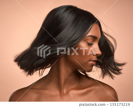 Hair care, beauty and young woman in studio with keratin, healthy or brazilian salon treatment. Wellness, cosmetic and female model with motion for shiny, clean and soft hairstyle by brown background Hair care, beauty and young woman in studio with keratin, healthy or brazilian salon treatment. Wellness, cosmetic and female model with motion for shiny, clean and soft hairstyle by brown background 135173219