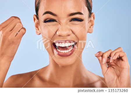 Happy woman, portrait and flossing teeth in dental, clean hygiene or healthcare against a studio background. Female person or model with smile in tooth whitening, floss or oral, gum or mouth cleaning Happy woman, portrait and flossing teeth in dental, clean hygiene or healthcare against a studio background. Female person or model with smile in tooth whitening, floss or oral, gum or mouth cleaning 135173260