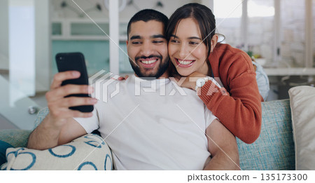 Phone, happy and couple with smile on sofa for social media post, online website and internet. Communication, relationship and man and woman relax on smartphone for quality time, bonding and network Phone, happy and couple with smile on sofa for social media post, online website and internet. Communication, relationship and man and woman relax on smartphone for quality time, bonding and network 135173300