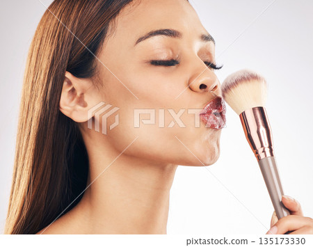 Beauty, makeup brush and woman in a studio with a natural, cosmetic and luxury face routine. Glamour, cosmetology and female model with a cosmetics product for cheeks isolated by a white background. 135173330