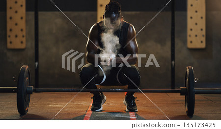 Weightlifting, powder and black man with barbell in gym for training, exercise and serious workout. Sports, strong muscle and male body builder lifting weights for challenge, wellness and strength Weightlifting, powder and black man with barbell in gym for training, exercise and serious workout. Sports, strong muscle and male body builder lifting weights for challenge, wellness and strength 135173425