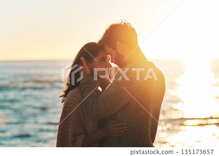 Sunset, beach and couple touching face for relaxing, bonding and quality time on romantic date. Nature, love and man and woman embrace for anniversary or honeymoon on holiday, weekend and vacation Sunset, beach and couple touching face for relaxing, bonding and quality time on romantic date. Nature, love and man and woman embrace for anniversary or honeymoon on holiday, weekend and vacation 135173657