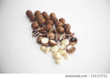Shelled macadamia nuts on a white background Shelled macadamia nuts on a white background 135173712