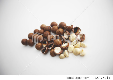 Shelled macadamia nuts on a white background Shelled macadamia nuts on a white background 135173713