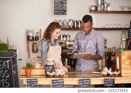 Tablet, restaurant and owner in teamwork of people, discussion and manage orders in store. Waiters, black man and happy woman in cafe with technology for inventory, stock check and managing sales. Tablet, restaurant and owner in teamwork of people, discussion and manage orders in store. Waiters, black man and happy woman in cafe with technology for inventory, stock check and managing sales. 135173953