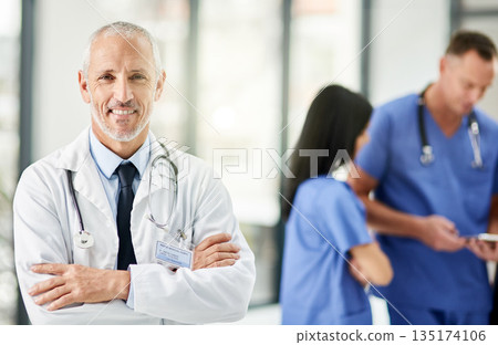 Healthcare, smile and portrait of senior doctor with arms crossed, pride and support in hospital. Health care, happiness and expert medicine, confident and happy man, medical professional in clinic. Healthcare, smile and portrait of senior doctor with arms crossed, pride and support in hospital. Health care, happiness and expert medicine, confident and happy man, medical professional in clinic. 135174106