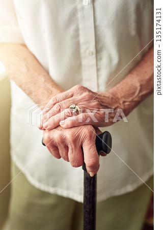 Hands, cane and closeup of senior woman with disabled injury with balance in retirement in house. Walking stick, elderly lady and person with disability, support or recovery in home with lens flare Hands, cane and closeup of senior woman with disabled injury with balance in retirement in house. Walking stick, elderly lady and person with disability, support or recovery in home with lens flare 135174131