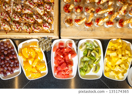 Top view of buffet table with fruit and appetizer assortment - abundance for event Top view of buffet table with fruit and appetizer assortment - abundance for event 135174365