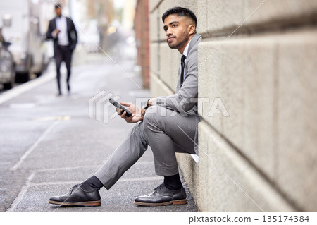 Thinking, phone and a businessman sitting in the city for social media, communication or email. Contact, ideas and a corporate person in a suit with a mobile for a chat, internet or notification Thinking, phone and a businessman sitting in the city for social media, communication or email. Contact, ideas and a corporate person in a suit with a mobile for a chat, internet or notification 135174384