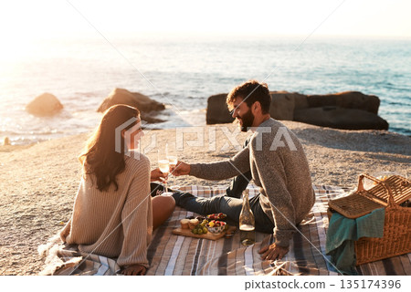 Picnic, beach and couple with champagne happy for relax, bonding and quality time on romantic date. Nature, dating and man and woman toast for anniversary, honeymoon and love on holiday or vacation Picnic, beach and couple with champagne happy for relax, bonding and quality time on romantic date. Nature, dating and man and woman toast for anniversary, honeymoon and love on holiday or vacation 135174396