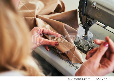 Sewing machine, woman hands and fashion designer with button and thread work. Small business, entrepreneur and female tailor with boutique and creative worker working with machinery for clothing Sewing machine, woman hands and fashion designer with button and thread work. Small business, entrepreneur and female tailor with boutique and creative worker working with machinery for clothing 135174590