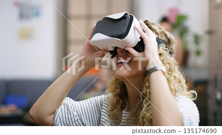 VR, future and woman in the metaverse, digital or virtual reality in a technology agency or futuristic startup company. Smile, fantasy and person happy to use internet, online and 3D web tech VR, future and woman in the metaverse, digital or virtual reality in a technology agency or futuristic startup company. Smile, fantasy and person happy to use internet, online and 3D web tech 135174690