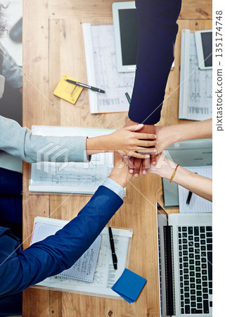 Top view, business people and stack hands at table in support of goals, synergy and target of success, agreement and trust. Closeup, integration and collaboration of teamwork in a winning circle Top view, business people and stack hands at table in support of goals, synergy and target of success, agreement and trust. Closeup, integration and collaboration of teamwork in a winning circle 135174748