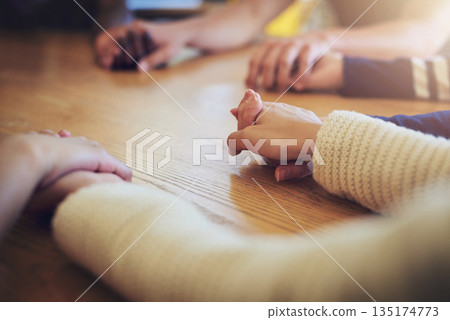 Circle, group and holding hands with people, praying and support for faith, trust or solidarity on desk. Teamwork, helping hand and together with pray, religion or spiritual with mindfulness on table 135174773