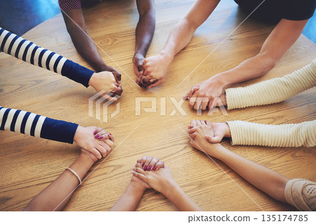 Circle, group and holding hands with people, pray and support for faith, trust or solidarity on desk. Teamwork, helping hand and together with praying, religion or gratitude with mindfulness on table 135174785