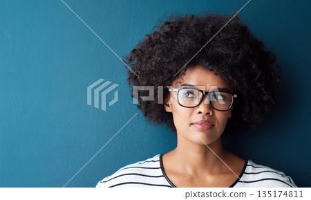 Optometry, thinking and woman with spectacles in a studio with daydreaming, pensive or idea face expression. Optical, vision and African female model with glasses by blue background with mockup. 135174811