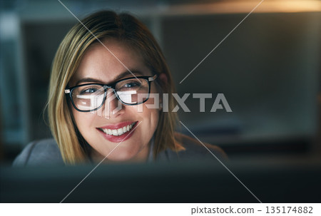 Happy, businesswoman and working late on a computer or overtime for a project deadline or schedule and in an office. Research, email and corporate worker with smile or analysis and report at night 135174882