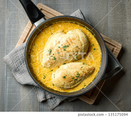 delicious chicken breast meat with creamy sauce on cooking pan 135175094