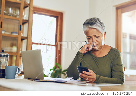 Senior woman, phone budget planning and health insurance checklist at home. Writing, contract and elderly female person with mobile banking, tax and pension form in a house with bills and debt 135175294