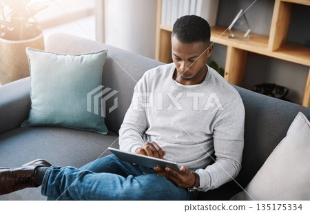 Relax, tablet and man on sofa from above with social media post, email or streaming video on subscription service. Networking, internet and connection, male surfing online shopping website on couch. Relax, tablet and man on sofa from above with social media post, email or streaming video on subscription service. Networking, internet and connection, male surfing online shopping website on couch. 135175334